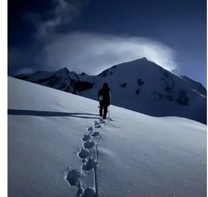 Climber moving through cold conditions on Wukuchu Peak