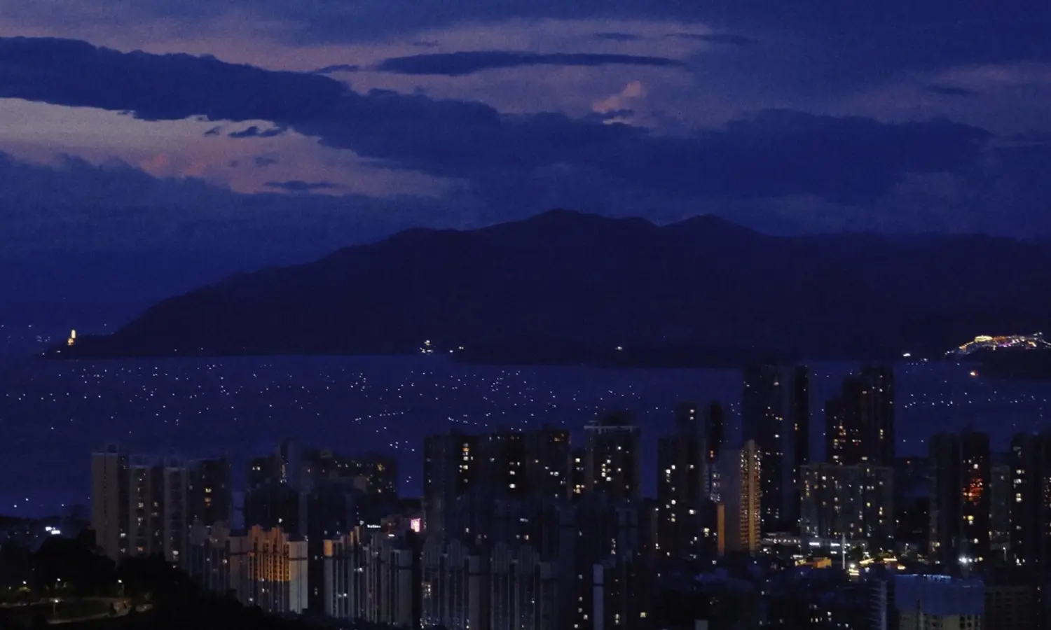 Cangshan and the lights of Dali beside Erhai Lake
