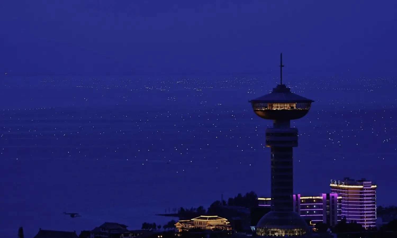 Fishing lights around Erhai Lake with the city tower in view