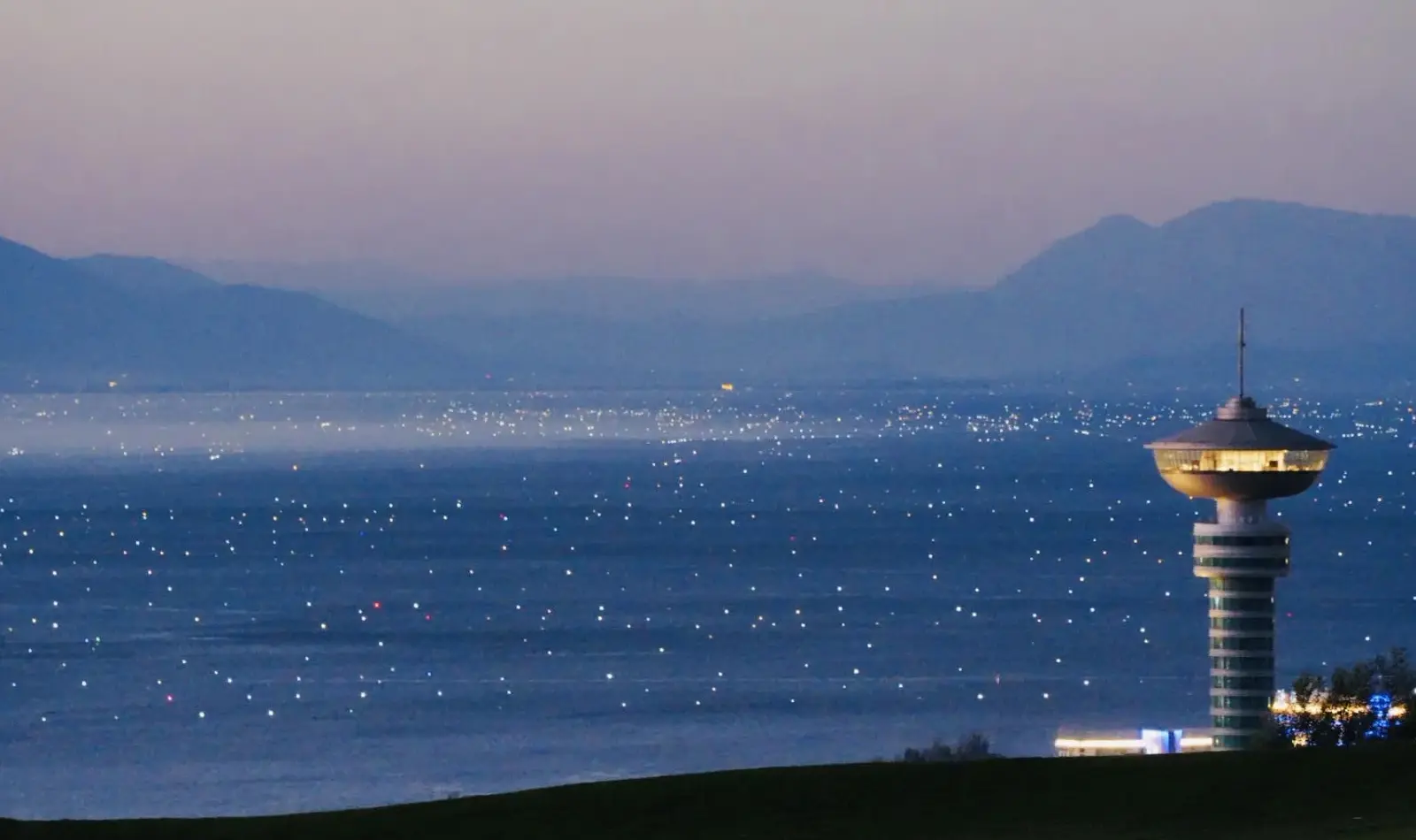 Fishing lights across Erhai Lake at dusk