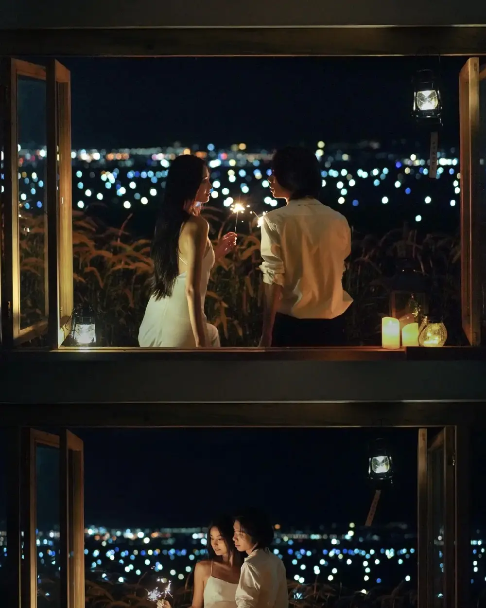 A couple looking out at Erhai fishing lights at night